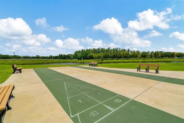 surrounding community featuring a yard and shuffleboard