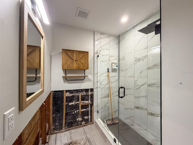 full bath with marble finish floor, a marble finish shower, and visible vents