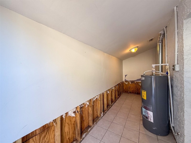 utility room featuring visible vents and electric water heater