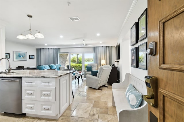 kitchen with visible vents, open floor plan, stainless steel dishwasher, light stone countertops, and stone tile flooring