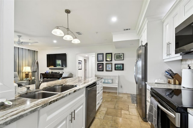 kitchen featuring stone tile flooring, visible vents, appliances with stainless steel finishes, white cabinetry, and a sink