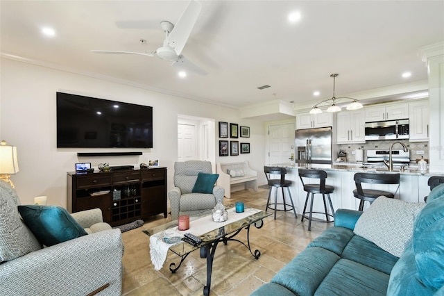 living area with light tile patterned floors, ornamental molding, a ceiling fan, and recessed lighting