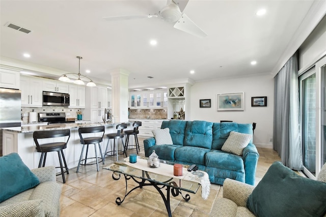 living room featuring crown molding, decorative columns, recessed lighting, visible vents, and a ceiling fan