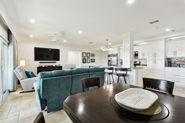 dining area featuring recessed lighting, decorative columns, a ceiling fan, visible vents, and stone tile flooring