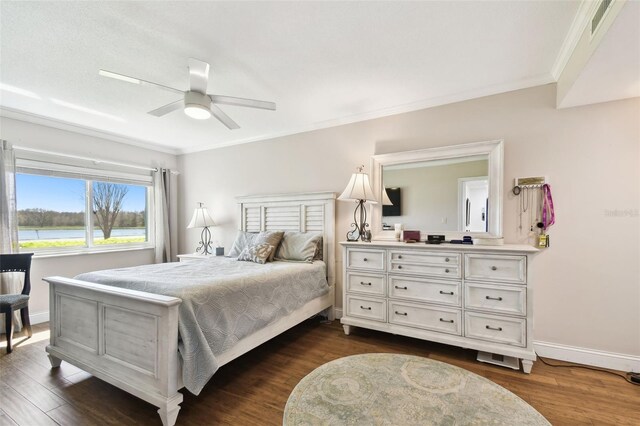 bedroom with ornamental molding, dark wood finished floors, baseboards, and ceiling fan