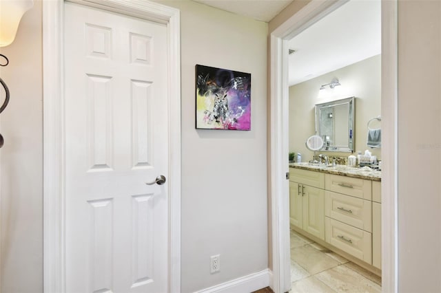 bathroom with baseboards and vanity