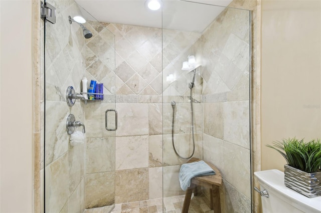 full bathroom featuring a stall shower and toilet