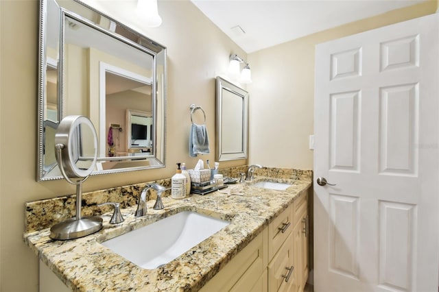 full bath with double vanity and a sink