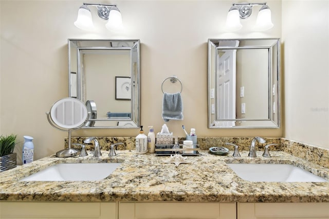 bathroom with a sink and double vanity