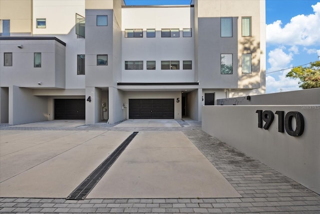 view of front of house with stucco siding and an attached garage