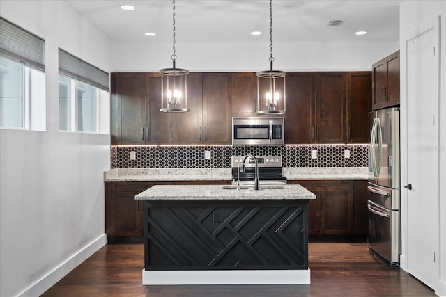 kitchen with a sink, stainless steel appliances, backsplash, and dark wood finished floors