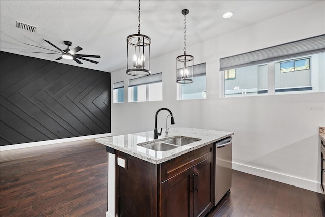 kitchen featuring visible vents, dark wood-type flooring, a sink, wooden walls, and dishwasher