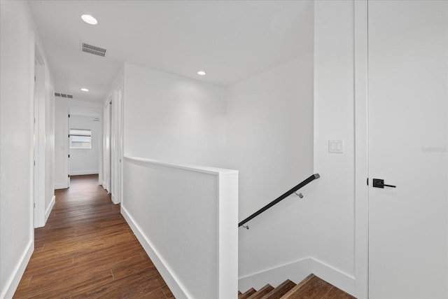 corridor featuring recessed lighting, visible vents, an upstairs landing, and wood finished floors