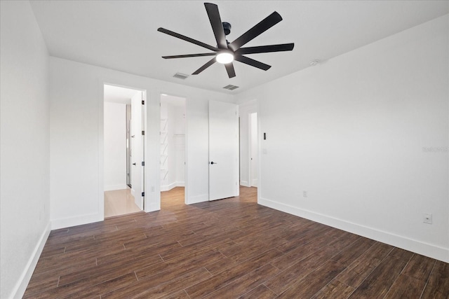 interior space with visible vents, baseboards, and dark wood-style floors