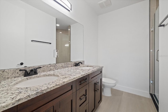 full bath with double vanity, a stall shower, toilet, and a sink