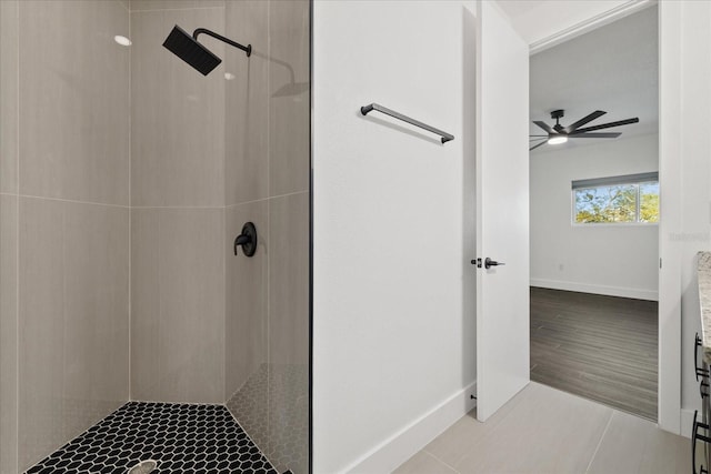 full bath featuring tile patterned floors, tiled shower, baseboards, and a ceiling fan