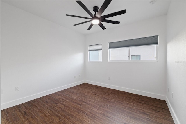 unfurnished room featuring baseboards, wood finished floors, and a ceiling fan