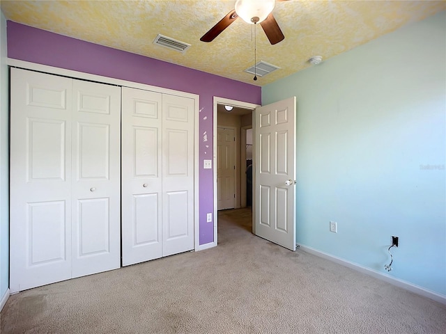 unfurnished bedroom featuring a closet, visible vents, carpet flooring, and baseboards