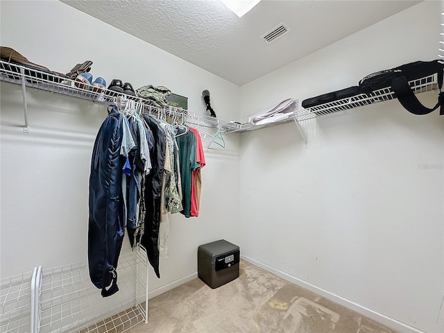 spacious closet featuring visible vents and carpet