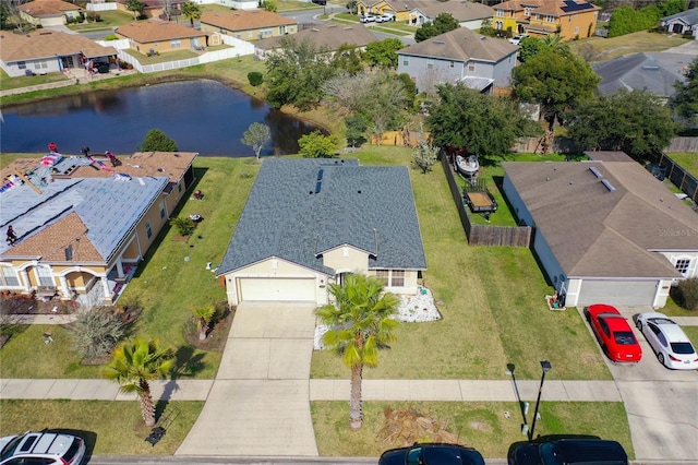 drone / aerial view with a residential view and a water view