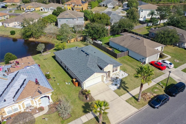 drone / aerial view with a residential view and a water view