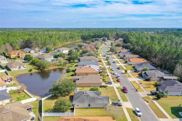 birds eye view of property with a residential view, a forest view, and a water view