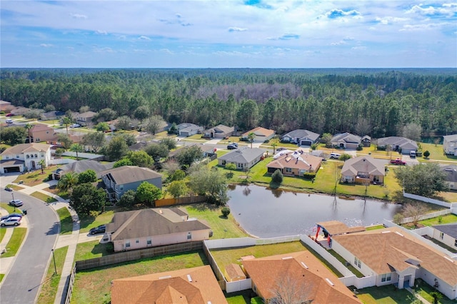 aerial view featuring a residential view, a forest view, and a water view