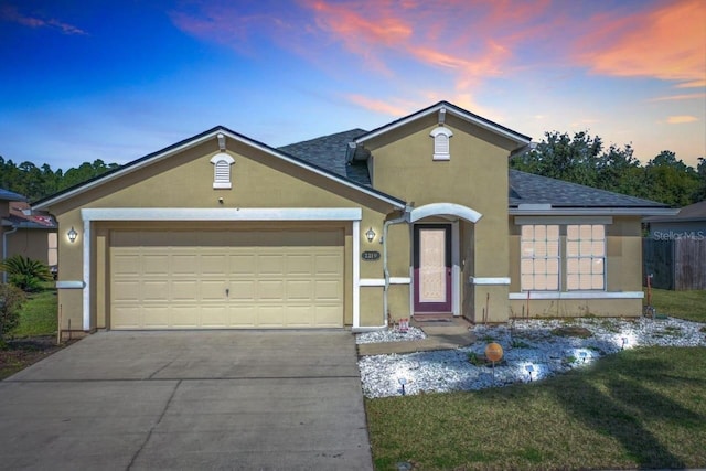 ranch-style house with a shingled roof, an attached garage, driveway, and stucco siding