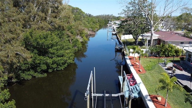 dock area featuring a water view and a lawn