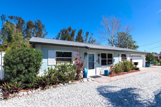 ranch-style house with concrete driveway and an attached garage