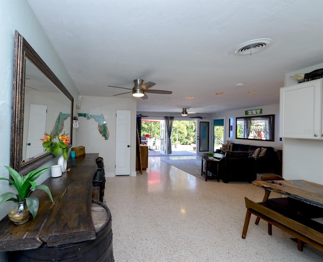 living room with visible vents and speckled floor