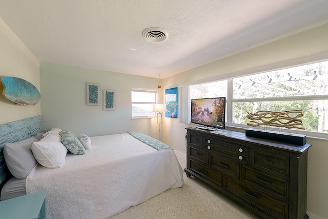 bedroom with light speckled floor, visible vents, and a textured ceiling