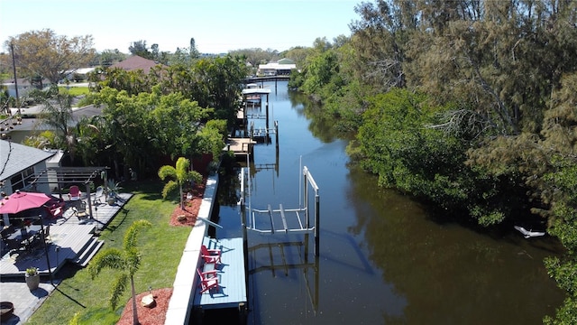 view of dock featuring a water view and a yard