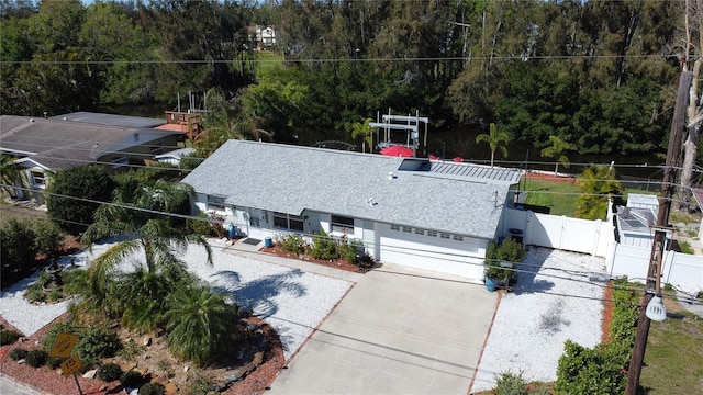 birds eye view of property with a view of trees