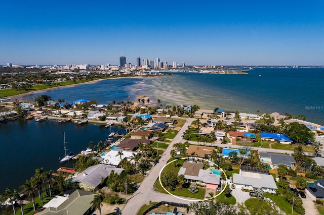 birds eye view of property with a water view and a city view