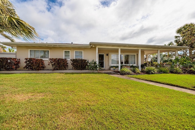 ranch-style house featuring a front yard and stucco siding