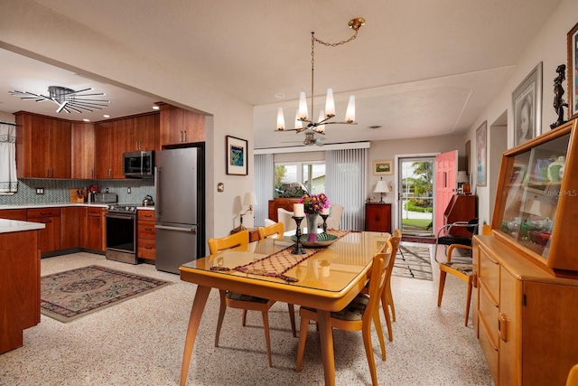 2340 W Bay Isle Dr SE, Saint Petersburg, FL 33705 - dining space with light speckled floor and an inviting chandelier
