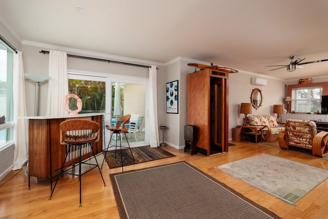 2340 W Bay Isle Dr SE, Saint Petersburg, FL 33705 - living area featuring light wood-style floors, a ceiling fan, and crown molding