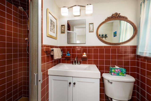 2340 W Bay Isle Dr SE, Saint Petersburg, FL 33705 - full bath with toilet, a wainscoted wall, vanity, tile walls, and a tile shower