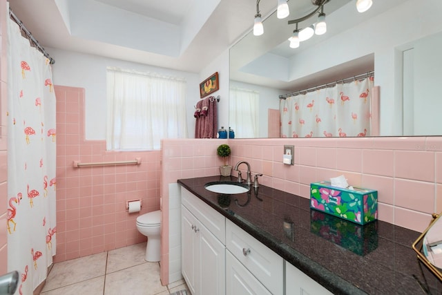 2340 W Bay Isle Dr SE, Saint Petersburg, FL 33705 - bathroom featuring tile walls, a raised ceiling, toilet, vanity, and tile patterned flooring