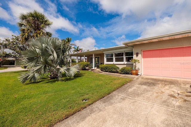 2340 W Bay Isle Dr SE, Saint Petersburg, FL 33705 - ranch-style house with a garage, driveway, a front lawn, and stucco siding