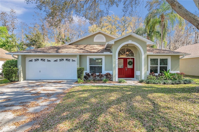 view of front of house with a garage, driveway, french doors, and stucco siding