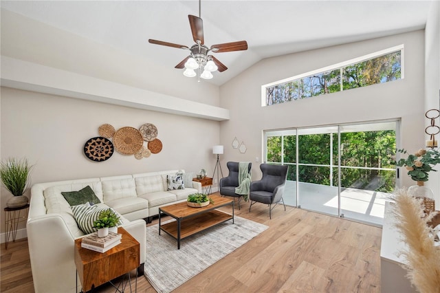 living area with a ceiling fan, high vaulted ceiling, and wood finished floors