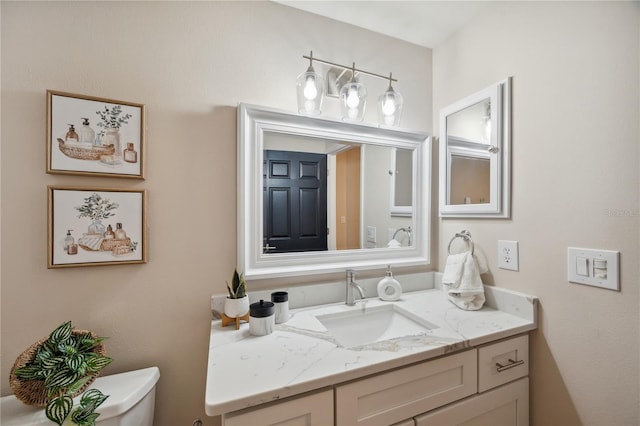 bathroom featuring vanity and toilet