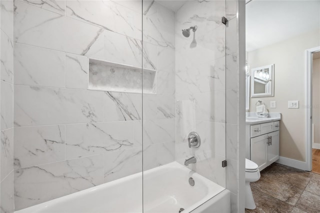 bathroom featuring toilet,  shower combination, vanity, and baseboards