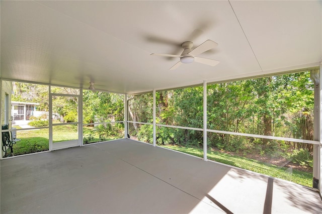 unfurnished sunroom featuring ceiling fan