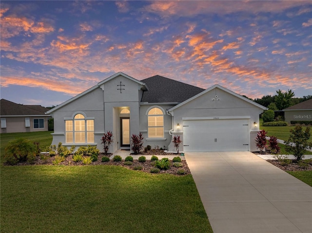 view of front of house featuring driveway, a front yard, and stucco siding