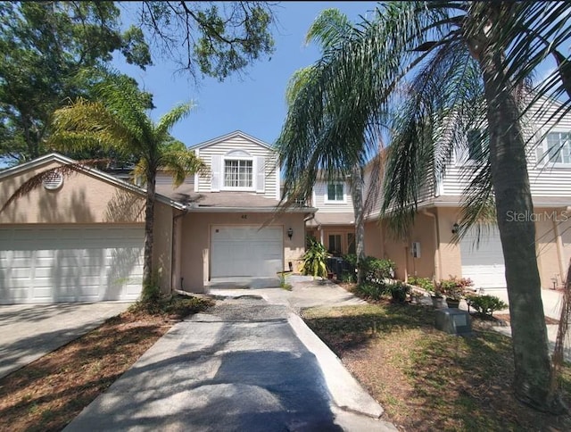 view of property with driveway and stucco siding