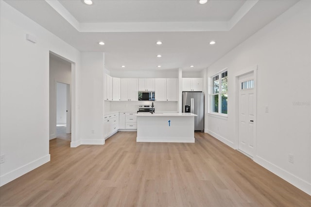 3902 E Henry Ave, Tampa, FL 33610 - kitchen featuring white cabinets, recessed lighting, stainless steel appliances, and light wood-style floors
