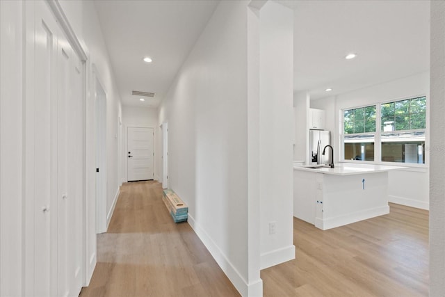 3902 E Henry Ave, Tampa, FL 33610 - hallway with baseboards, light wood-style flooring, visible vents, and recessed lighting